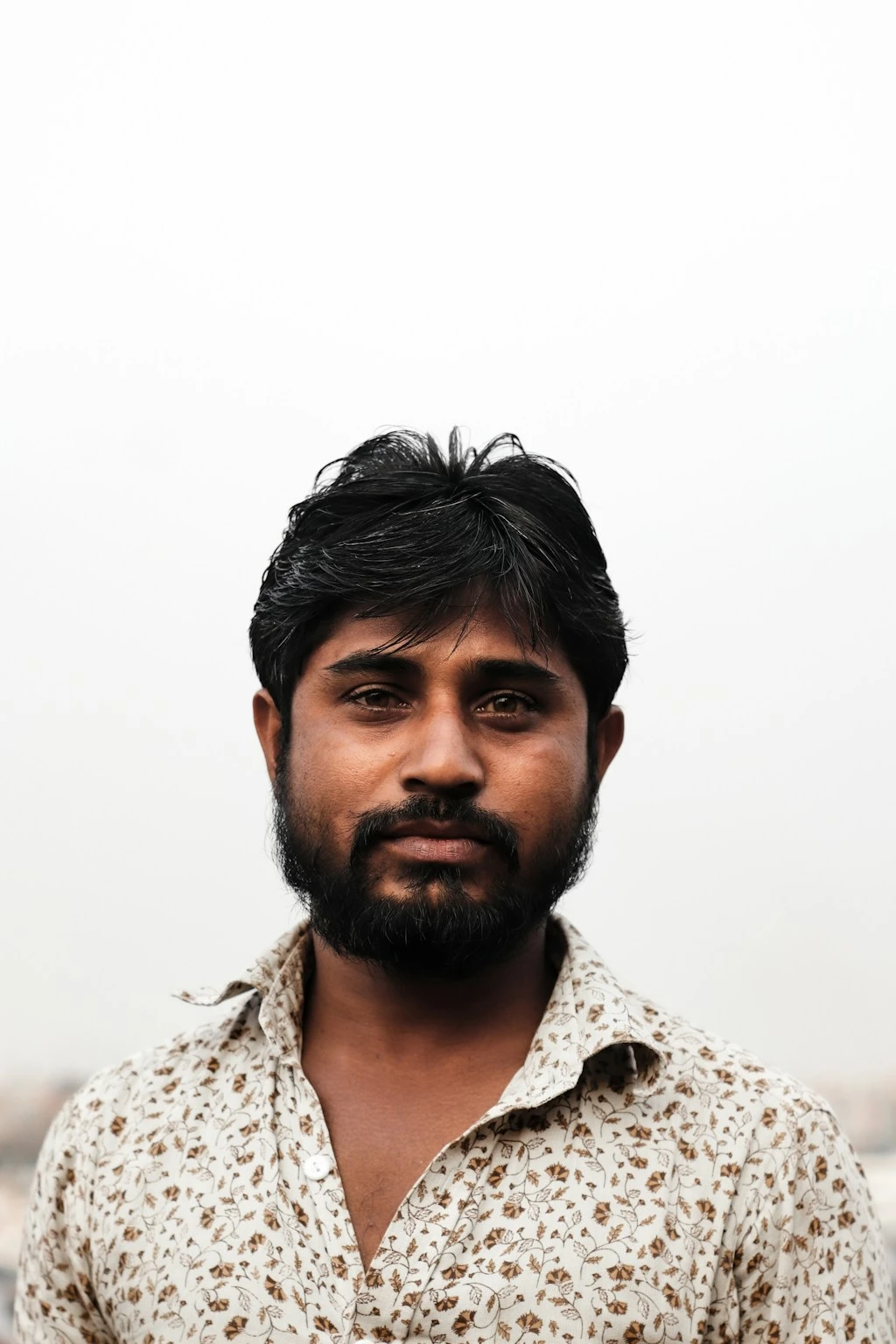 Original uploaded portrait of a bearded adult wearing a patterned shirt